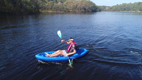 kid kayaking on lake