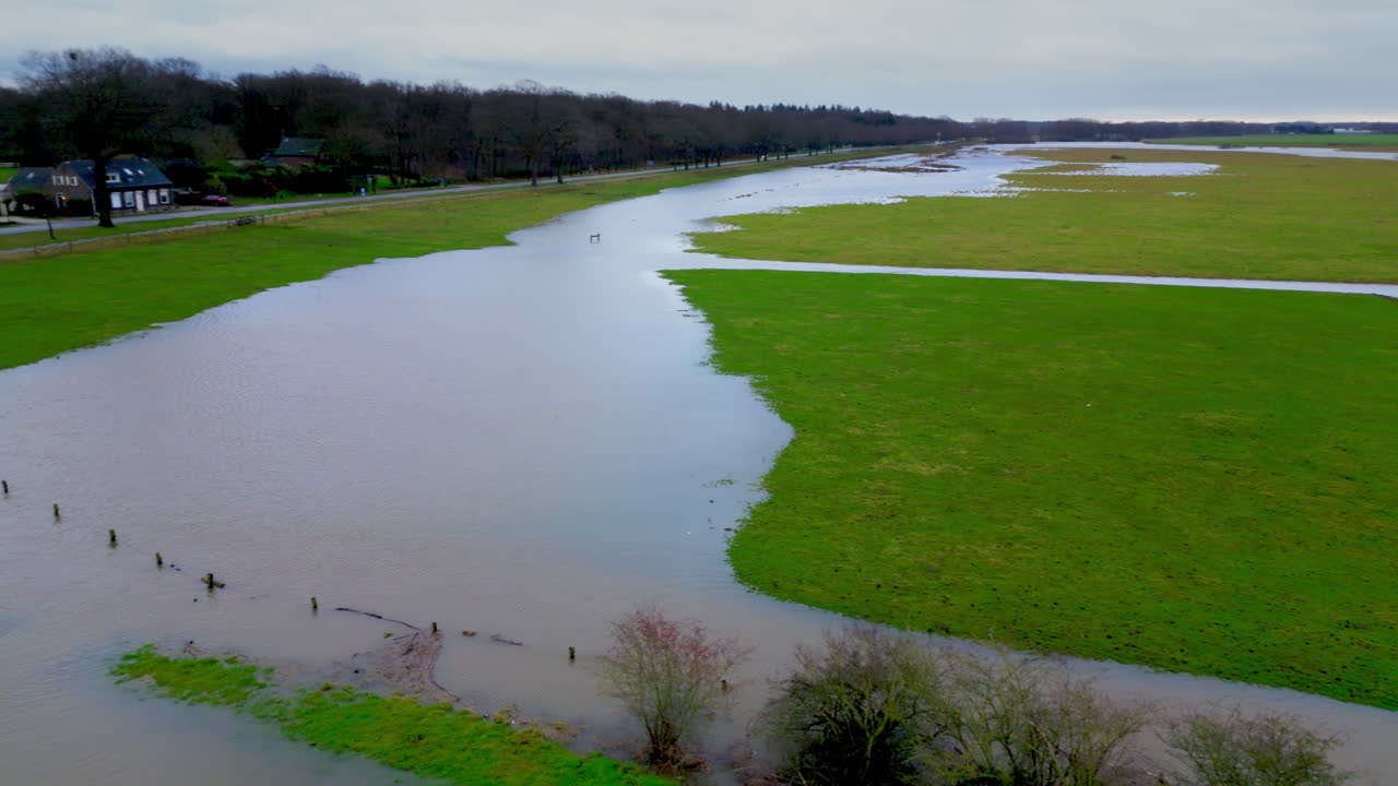 Pan to the right of flooded Limburg landscape in the Netherlands in the winter of 2024