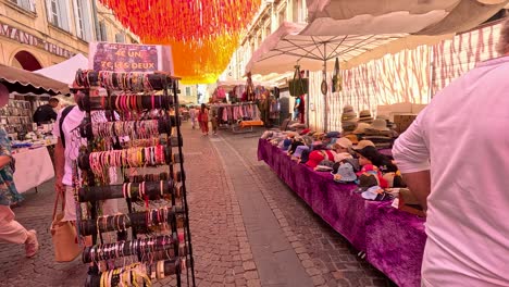 colorful market stalls with hats and bags