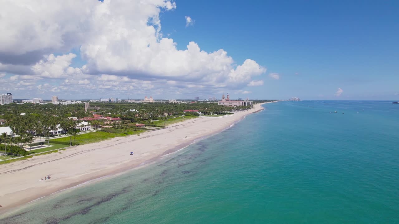 Drone bird's eye view of west palm beach skyline downtown area and beautiful beach sand and boats in water