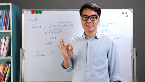 male asian teacher showing ok sign