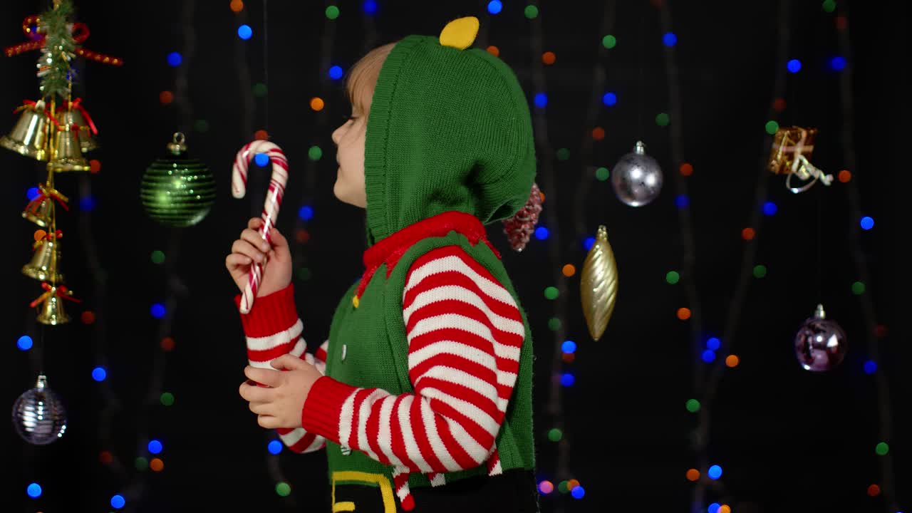 niña navidad elfo santa ayudante steeples dedos esperando para la caja de regalos. niño en las vacaciones de año nuevo