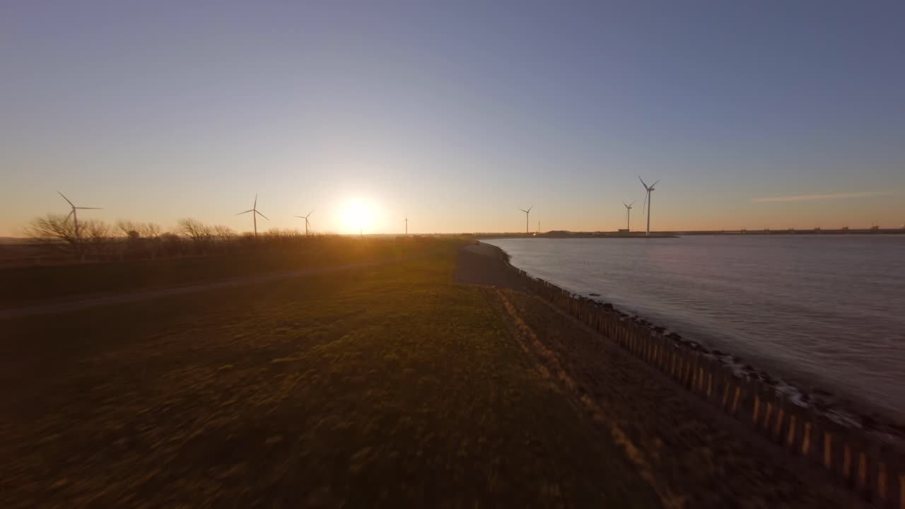 High to low angle shot above a Dutch dyke with view on the storm surge barrier