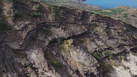 drone aerial pan down cliff side beach front