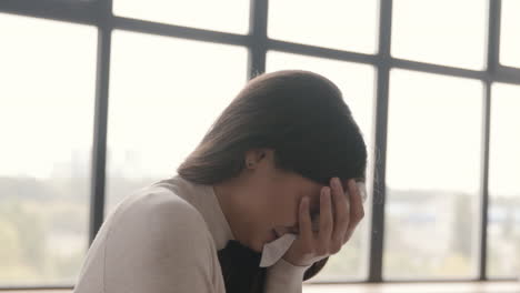 sad woman crying while sitting on sofa at home 1