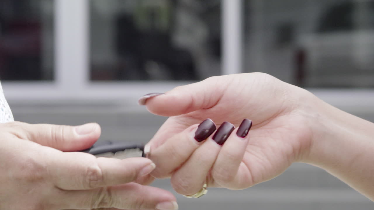 자동차 키를 건네주는 여성 손