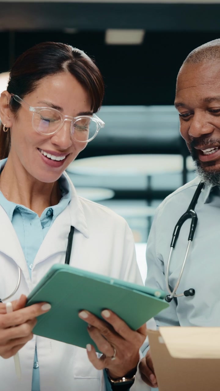 Two Doctors Discussing Medical Records and High Fiving in Hospital