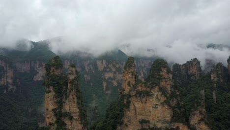 ethereal and beautiful rock spires rise over misty forest china valley