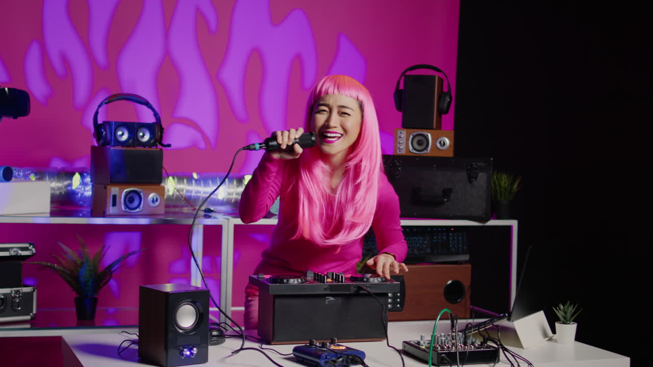 Woman with pink hair DJing and singing