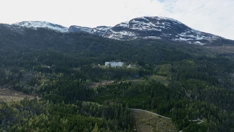 Harastolen-Luster---Aerial-approaching-majestic-mountain-building-with-historic-Tuberculosis-sanatorium-and-mental-hospital