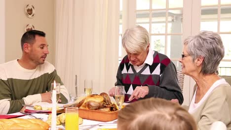 three generation family having christmas dinner together