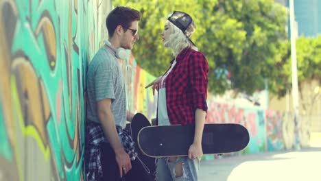 Young-trendy-urban-couple-standing-chatting