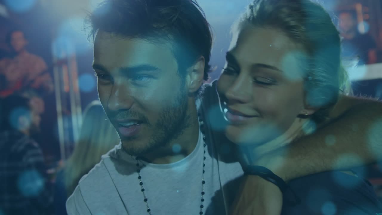 Man and woman leaning close, woman draping arm, performer playing, sharing moment, bokeh over them