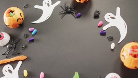 Multiple-halloween-toys-and-candies-with-copy-space-on-grey-background