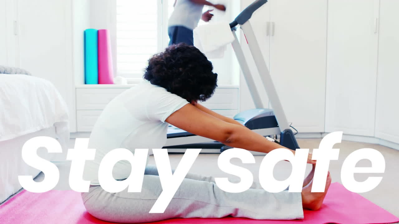 Animation os stay safe text over man and woman exercising at home