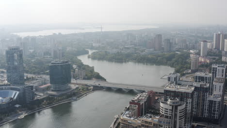 aerial view of a city by a river with fog