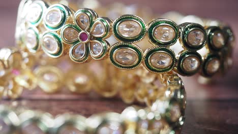 close-up of gold bangles with diamonds and ruby