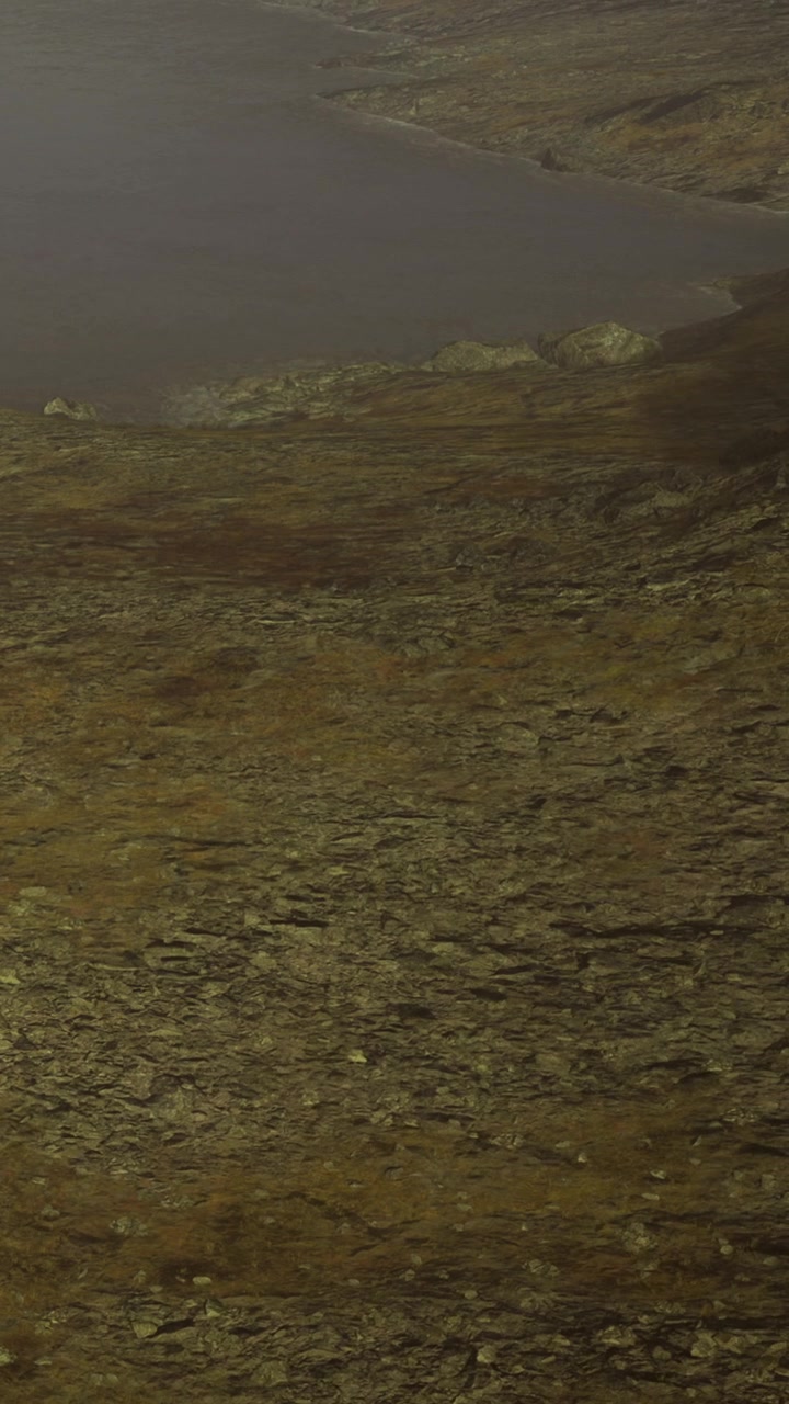 Landscape view of rocky terrain near water at dusk