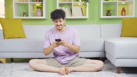 Cheerful-young-man-texting.