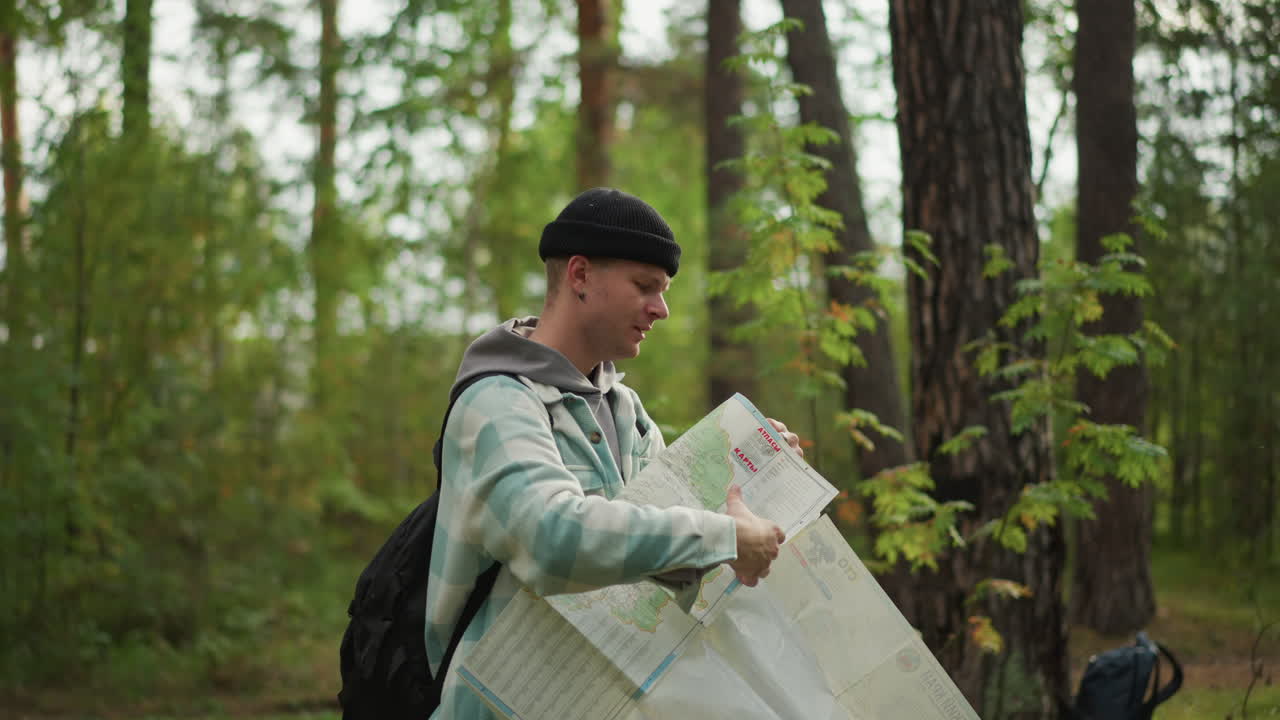 Happy explorer finds way, Young hiker confidently navigates forest trail, Confident young traveler discovers new pathway through woods, Joyful novice trekker uncovers her intended course in forest