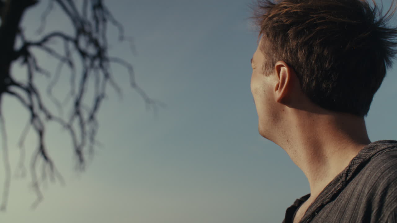 Man Outdoors with Mustache Looking Thoughtful