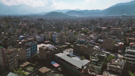 bird eye view of kathmandu city and it buildings with a range of mountains in the background - nepal