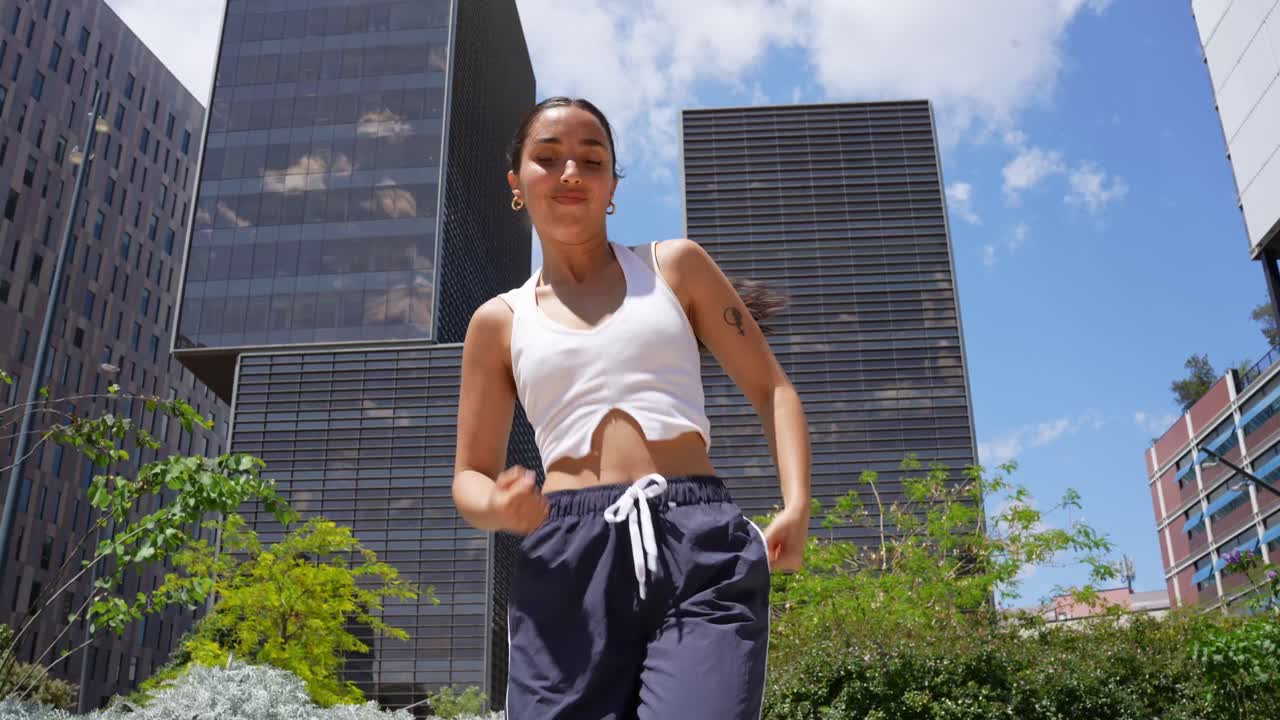 Woman dancing in an urban park setting