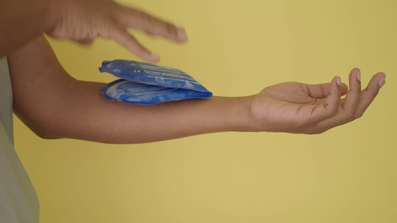 Applying an ice pack to the arm for pain relief