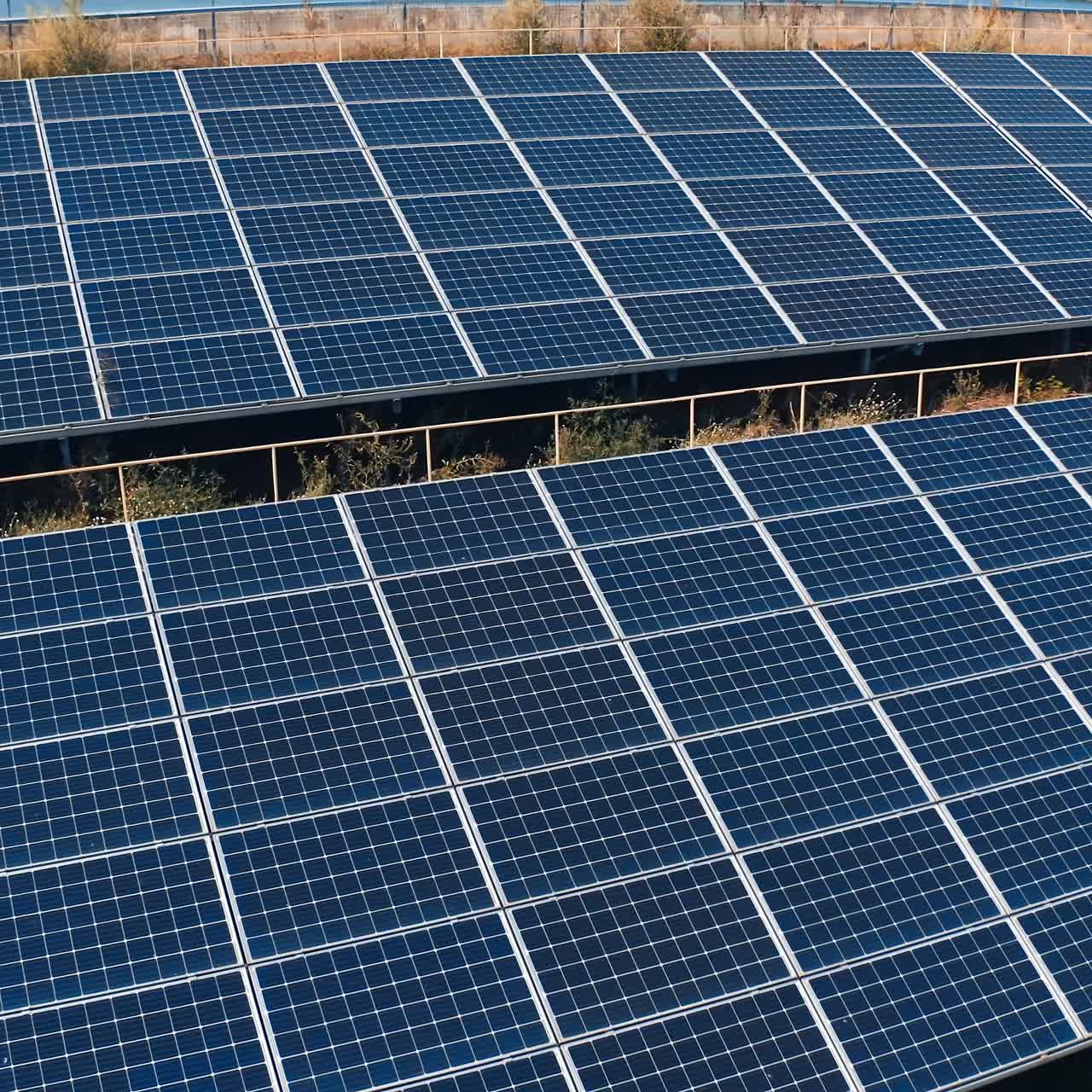 Photovoltaic panels at sunlight. Blue solar panels on the ground. Alternative source of clean energy from the sun. Drone flight