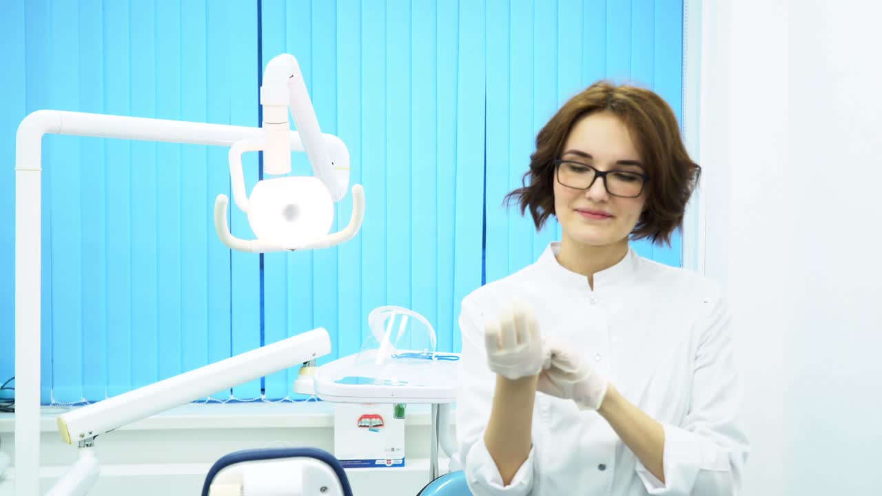 el dentista se pone los guantes.