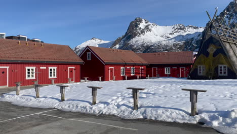 Panning-shot-of-Lamholmen-in-Svolvaer,-with-traditional-Norwegian-Rorbu,-Fisherman-Cabins-on-a-sunny-day-with-blue-sky,-Lofoten-Island