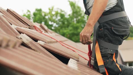 Static-shot-of-professional-technician-preparing-the-roof-for-installation-of-modern-solar-panels