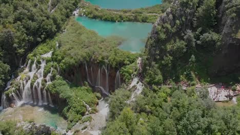 Panning-down-drone-shot-of-a-series-of-waterfalls