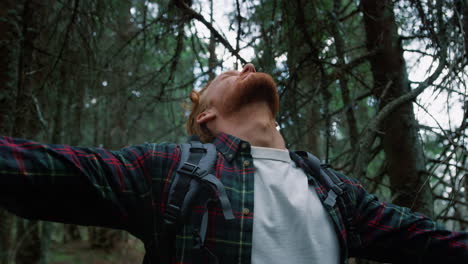 male hiker enjoying fresh air in the woods