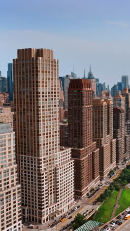 new york city buildifing on aerial view. flying backwards above nyc city.