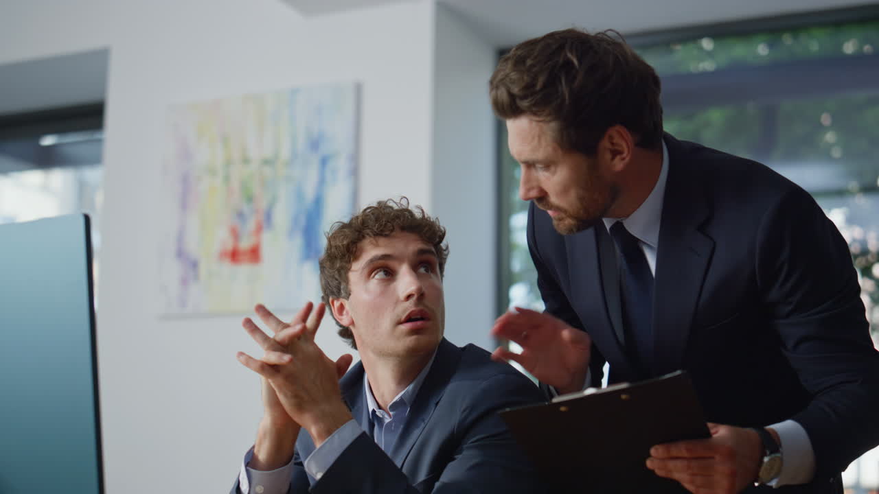 Man mentor helping colleague solving problem at office coworking space closeup