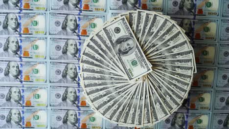 dollar banknotes background. hundred american dollars bills rotating in a circle way among colorful money. financial background. selective focus.