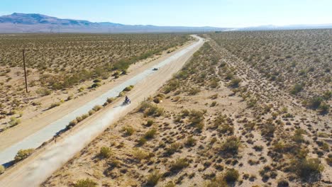 Vista-Aérea-over-an-ATV-dune-buggy-dirt-vehicle-on-a-dirt-road-through-the-desert-raises-dust-and-suggests-outdoor-advanture-1