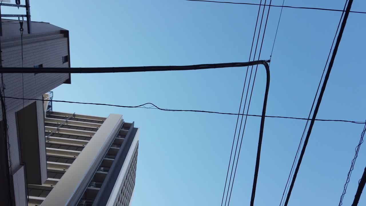 POV to the sky while walking in the local area in tokyo small area town with clear blue sky