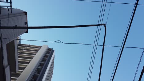 pov to the sky while walking in the local area in tokyo small area town with clear blue sky