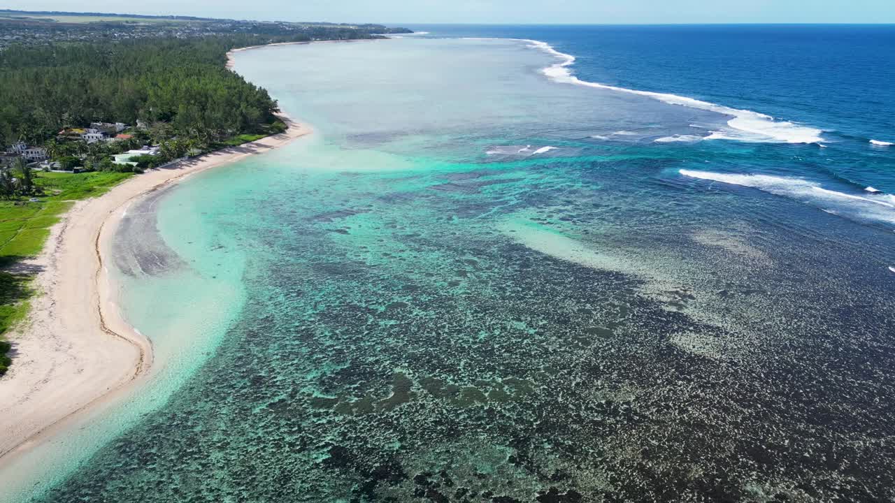 Aerial View of a Tropical Coastline with Clear Turquoise Waters and Coral Reefs