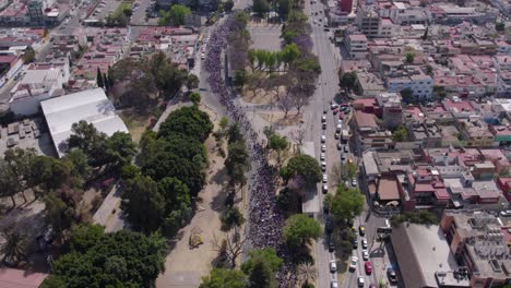 drone footage in slowmotion of the womans day march in one of the main cities of mexico, puebla city