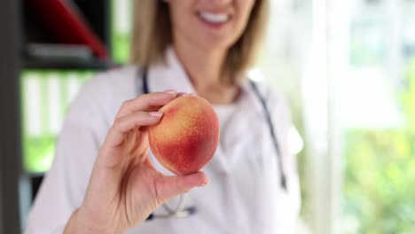 Doctor holding a peach