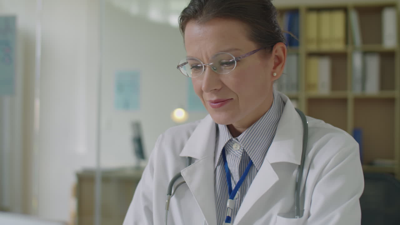 Female Doctor Working on Laptop at Office Desk