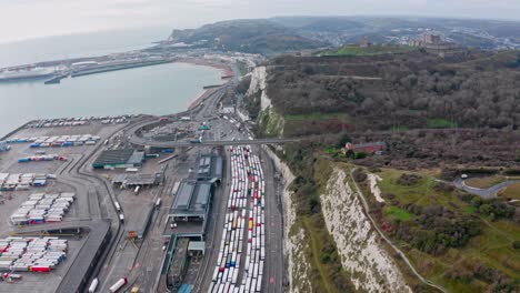 aerial drone shot of trucks queueing to leave the uk at dover to calais harbour brexit