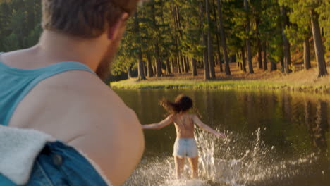 pareja feliz chapoteando en el lago al atardecer divirtiéndose jugando en el agua disfrutando del amor de verano