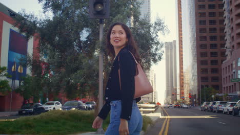young businesswoman crossing city street. asian woman going on crosswalk closeup