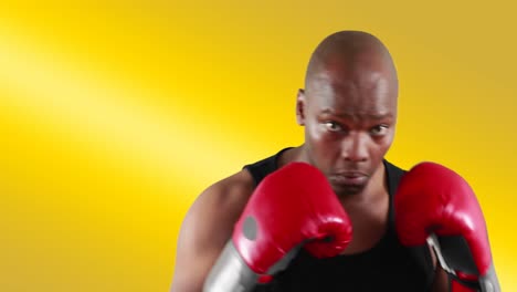 african american male boxer punching air on yellow background