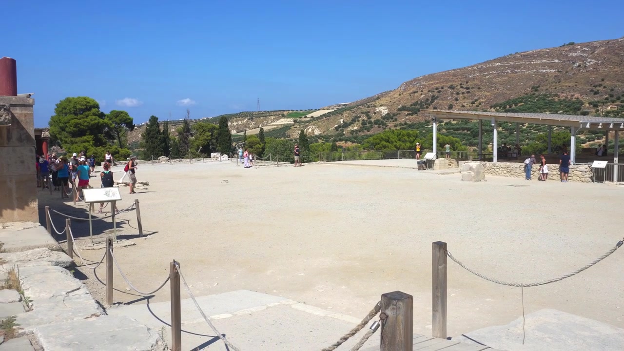 Tourists visiting ruins of Knossos palace in Greece