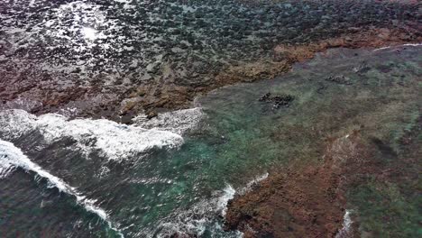 corralejo's rocky coastline with clear turquoise waters, fuerteventura, aerial view